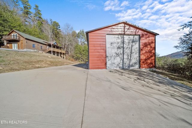 view of outbuilding with a garage and a yard