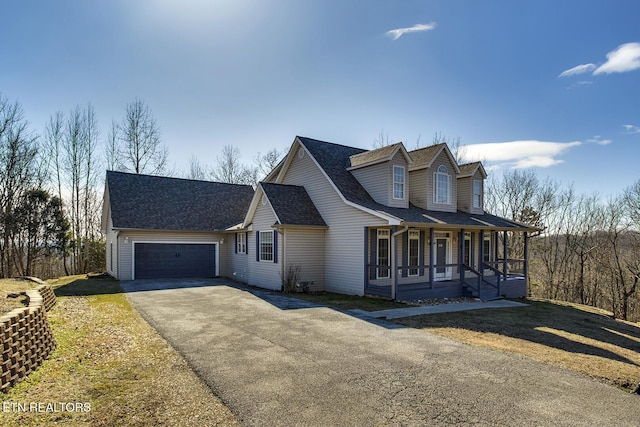 cape cod house with a porch and a garage