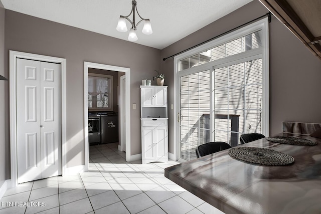 dining area with a chandelier and light tile patterned flooring