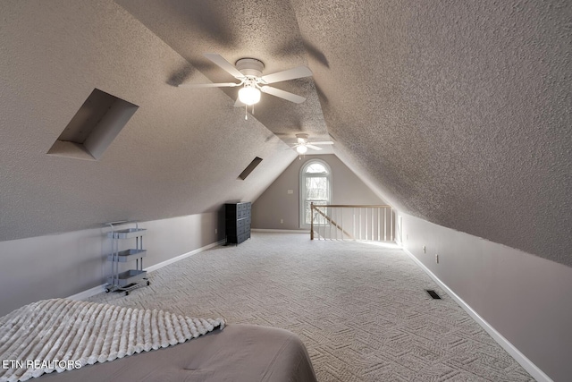 carpeted bedroom with ceiling fan and lofted ceiling