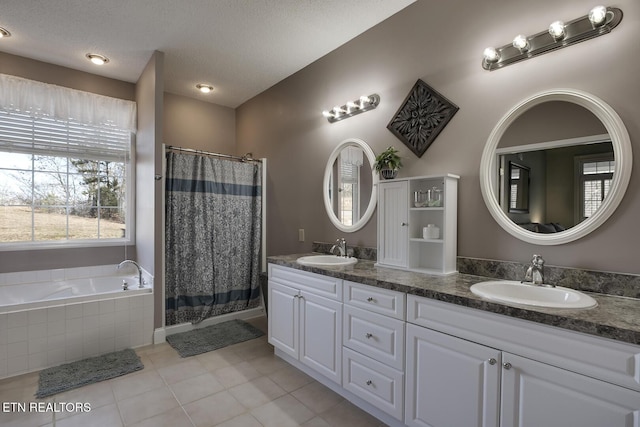 bathroom featuring vanity, plus walk in shower, tile patterned flooring, and a textured ceiling