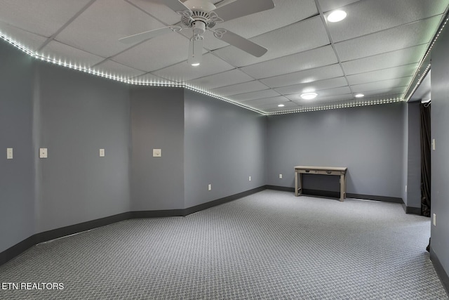 empty room with carpet flooring, a paneled ceiling, and ceiling fan