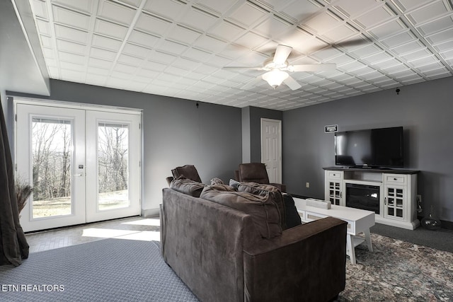 living room with a healthy amount of sunlight, carpet floors, and french doors