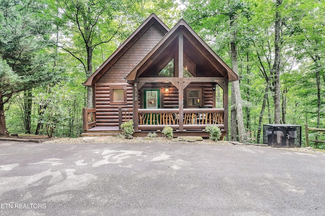 log-style house featuring a porch