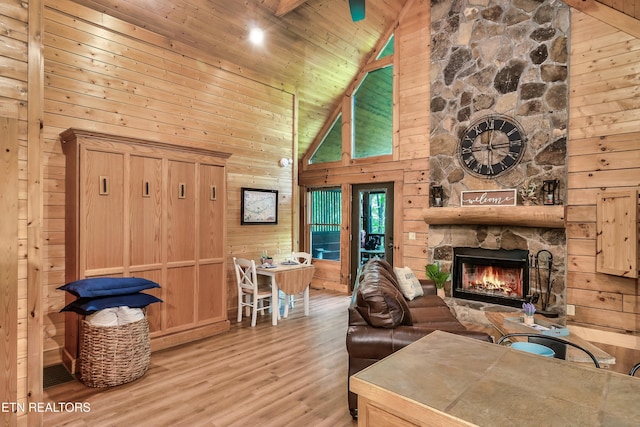 living room with high vaulted ceiling, beamed ceiling, wood walls, and wooden ceiling