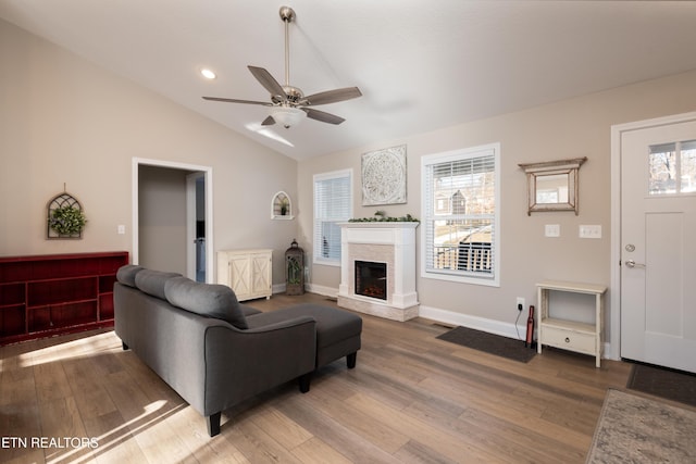 living room featuring ceiling fan, hardwood / wood-style floors, and a wealth of natural light