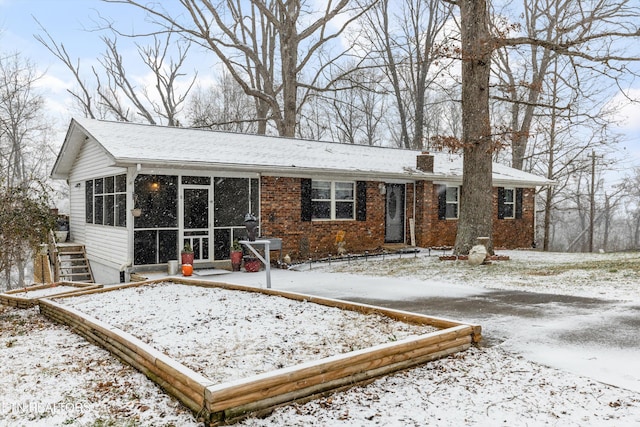 view of front facade with a sunroom