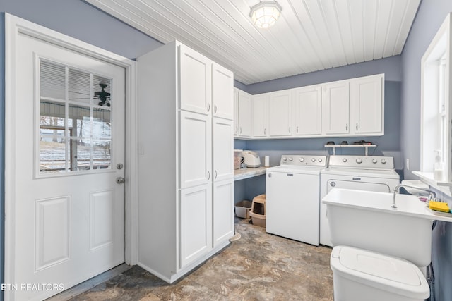 laundry room with washer and clothes dryer, sink, and cabinets