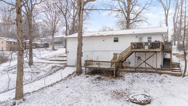 snow covered house featuring a deck