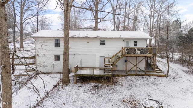 snow covered property featuring a deck