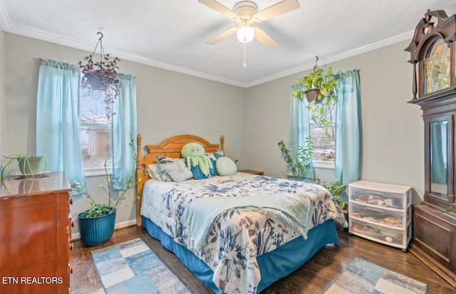 bedroom featuring ceiling fan, dark hardwood / wood-style flooring, and crown molding