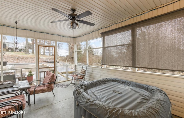 sunroom featuring ceiling fan and a jacuzzi