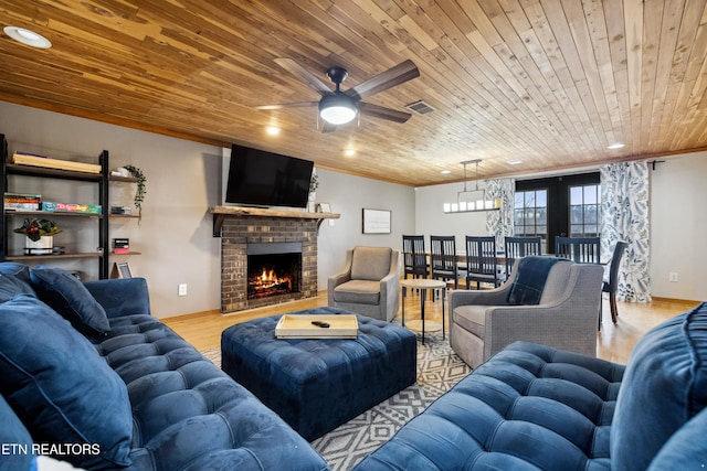 living room featuring french doors, light hardwood / wood-style floors, a fireplace, ceiling fan, and wooden ceiling