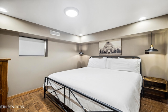 bedroom with dark wood-type flooring