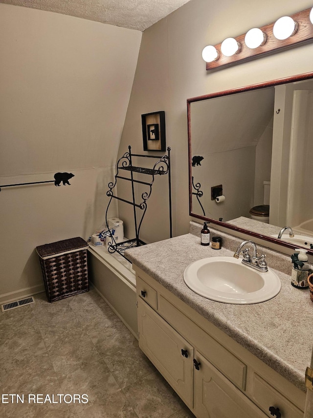 537 Gatlin Dr, Gatlinburg, TN 37738 - bathroom featuring a textured ceiling, visible vents, vanity, and baseboards