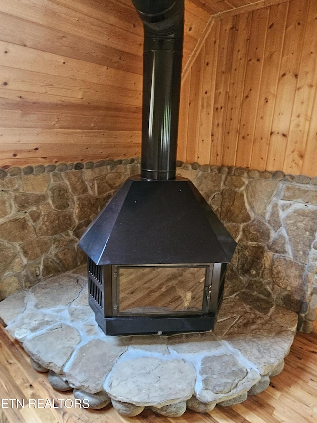 537 Gatlin Dr, Gatlinburg, TN 37738 - interior details featuring wood walls, wood finished floors, and a wood stove
