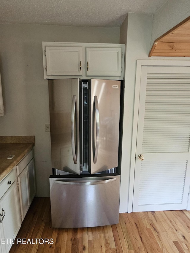 537 Gatlin Dr, Gatlinburg, TN 37738 - kitchen with white cabinets, freestanding refrigerator, and wood finished floors