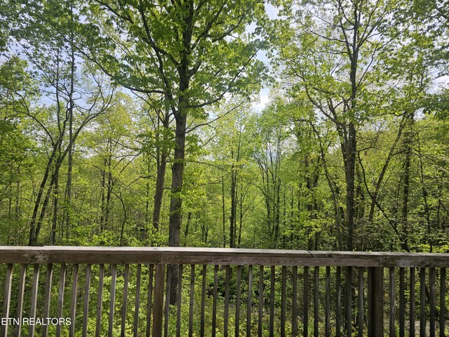 537 Gatlin Dr, Gatlinburg, TN 37738 - wooden terrace with a view of trees