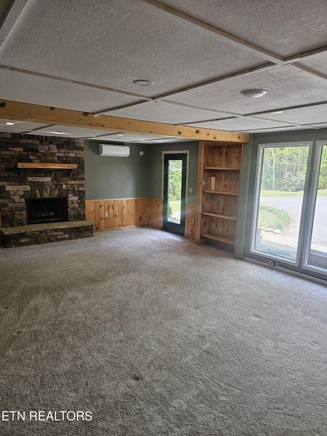 537 Gatlin Dr, Gatlinburg, TN 37738 - unfurnished living room with a wall mounted air conditioner, wooden walls, carpet, a textured ceiling, and wainscoting