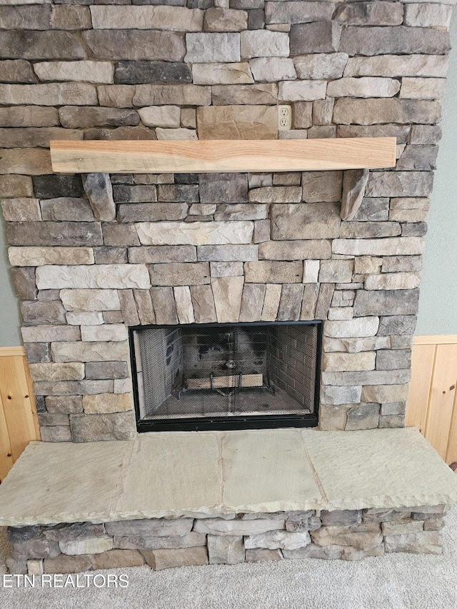 537 Gatlin Dr, Gatlinburg, TN 37738 - details with wooden walls, a wainscoted wall, and a stone fireplace