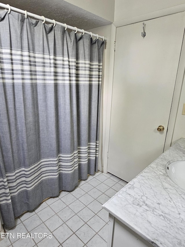 537 Gatlin Dr, Gatlinburg, TN 37738 - full bathroom with tile patterned flooring, vanity, and a shower with shower curtain