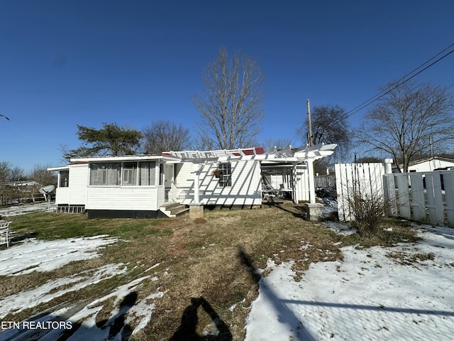 view of front of house featuring a sunroom