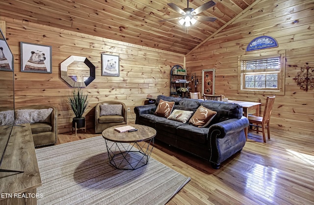 living room with wooden walls, wooden ceiling, vaulted ceiling, and hardwood / wood-style flooring