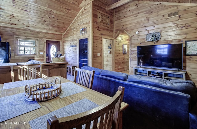 dining area with hardwood / wood-style flooring, high vaulted ceiling, wood walls, and wood ceiling