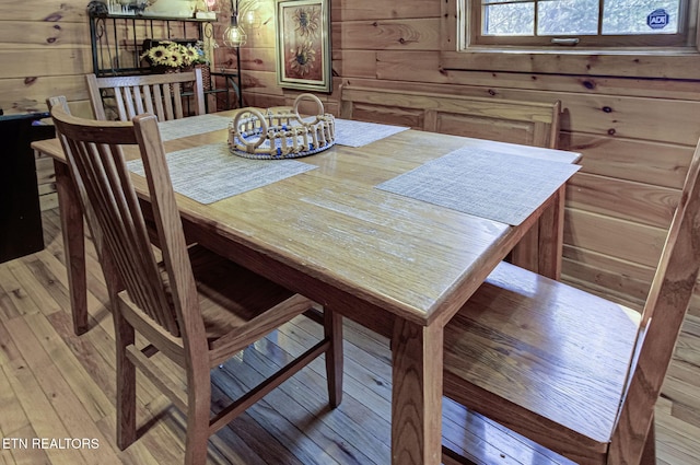 dining space with wood walls