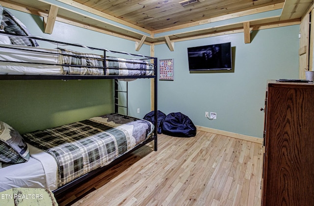 bedroom with light hardwood / wood-style floors and wood ceiling