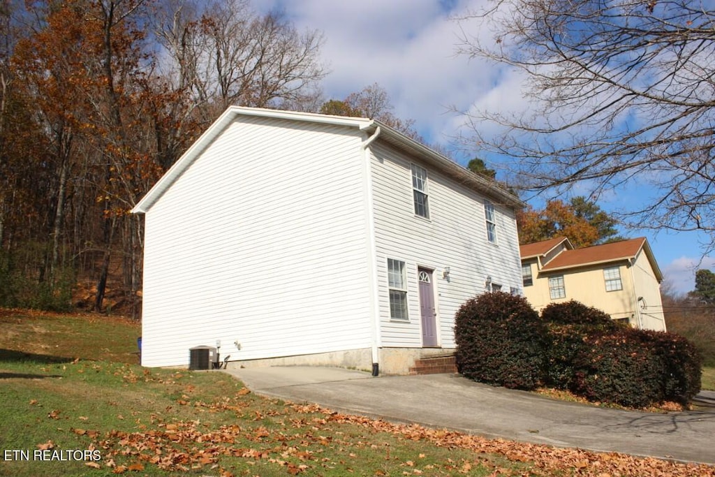 view of property exterior with a yard