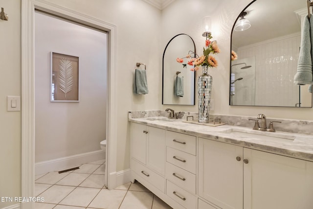 bathroom featuring a shower, tile patterned flooring, vanity, ornamental molding, and toilet