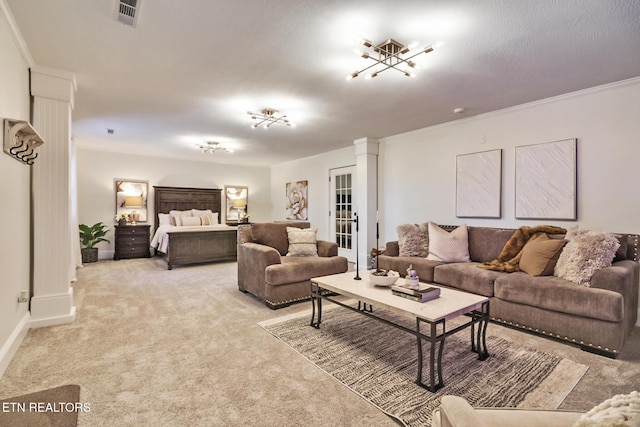 living room featuring crown molding, decorative columns, and light carpet