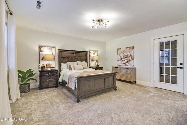 bedroom with ornamental molding and light carpet