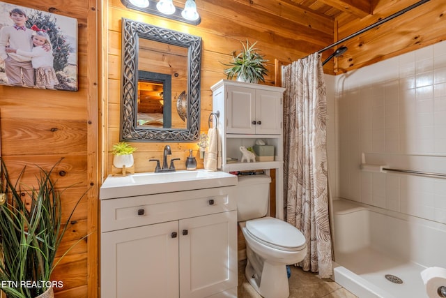 bathroom with vanity, toilet, wooden walls, and walk in shower