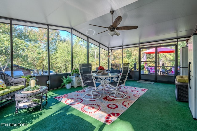 sunroom / solarium with ceiling fan and vaulted ceiling