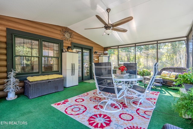 sunroom with ceiling fan and lofted ceiling