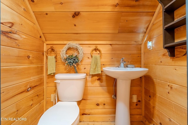 bathroom with wooden ceiling, toilet, lofted ceiling, and wooden walls