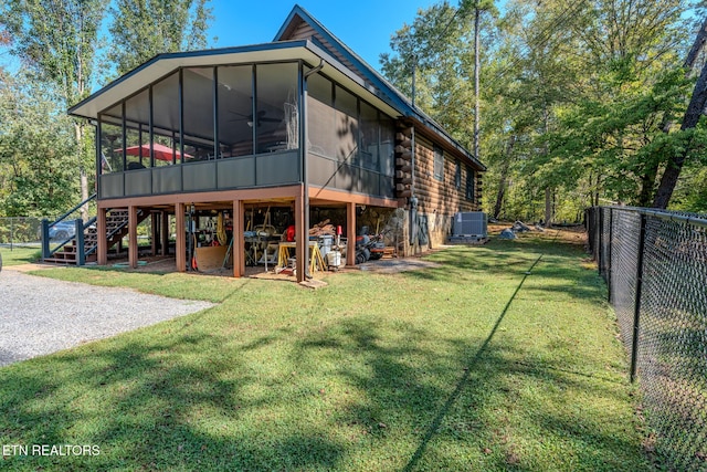 back of house with a lawn, central AC, and a sunroom