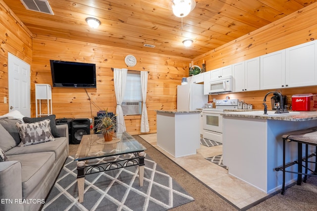 kitchen featuring wooden ceiling, white appliances, white cabinets, a breakfast bar, and sink