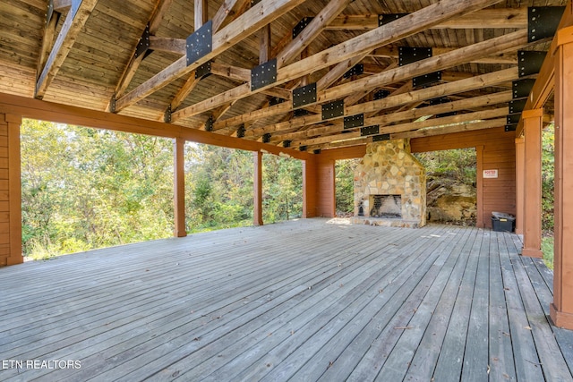 wooden terrace featuring an outdoor stone fireplace