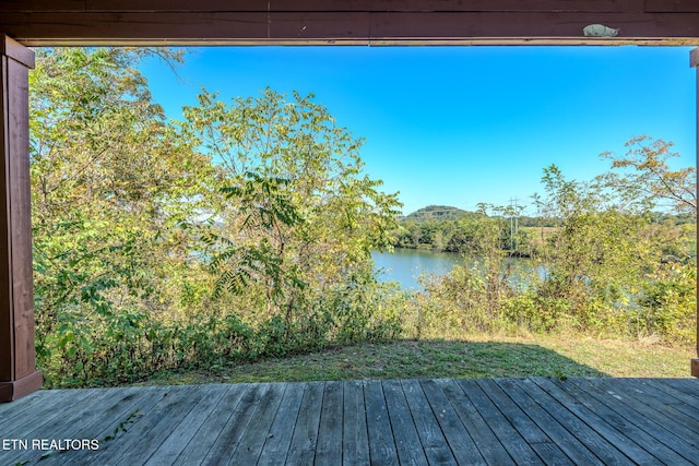 wooden terrace featuring a water view