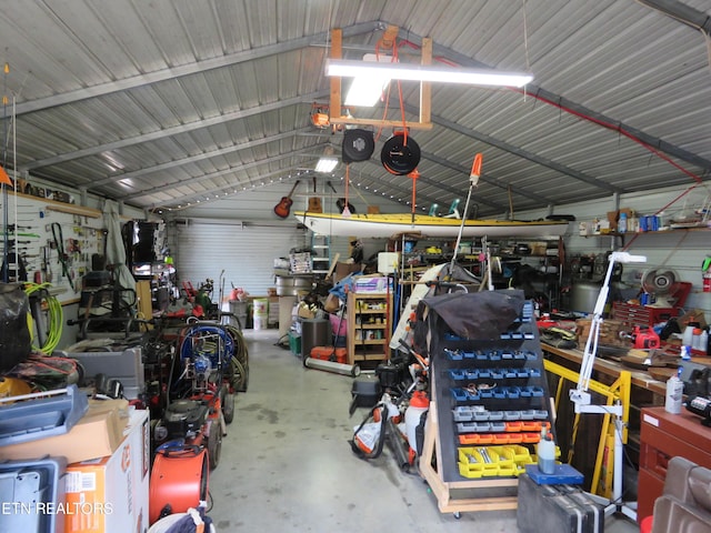 garage with a workshop area and metal wall