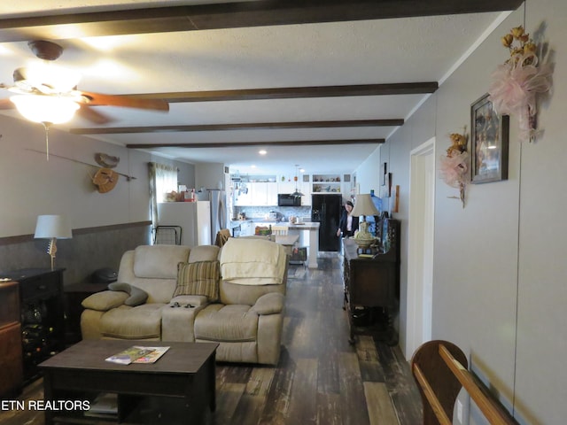 living room featuring beam ceiling and dark wood-style floors