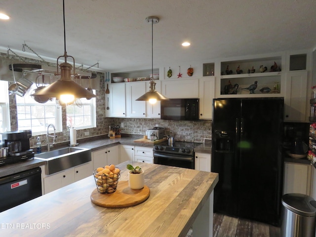 kitchen with a sink, open shelves, black appliances, and white cabinets