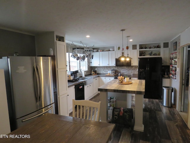 kitchen with wooden counters, decorative backsplash, white cabinets, black appliances, and open shelves