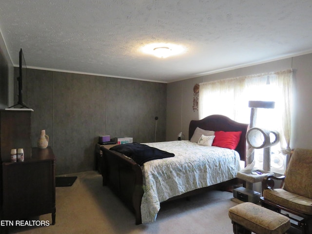 carpeted bedroom with a textured ceiling and ornamental molding