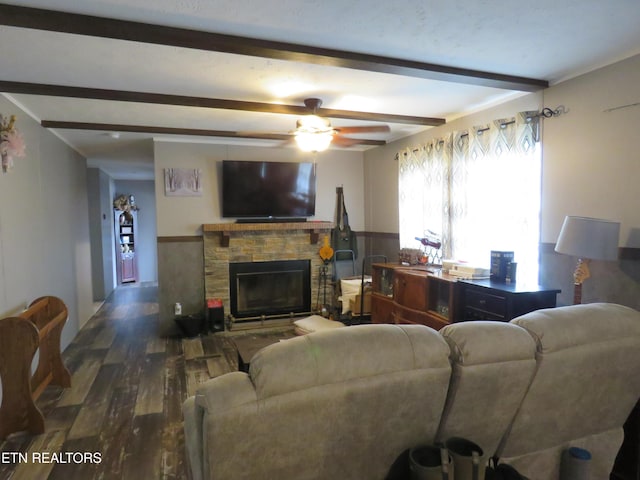 living room with wood finished floors, a fireplace, ceiling fan, wainscoting, and beamed ceiling