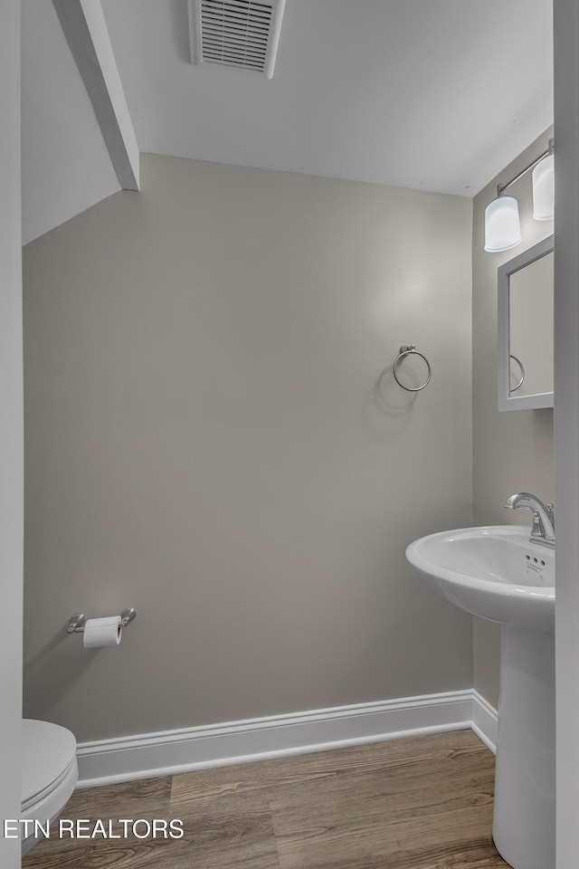 bathroom featuring toilet and hardwood / wood-style flooring