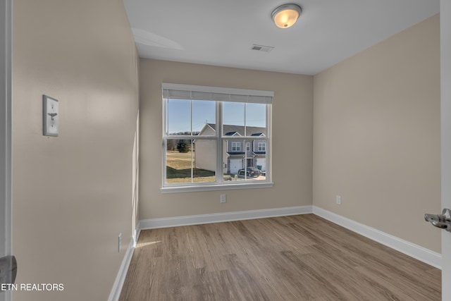 unfurnished room featuring light hardwood / wood-style floors